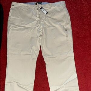 Tommy Hilfiger Men's THFLEX casual pants in khaki. Plus, a pair of TH dress pnts